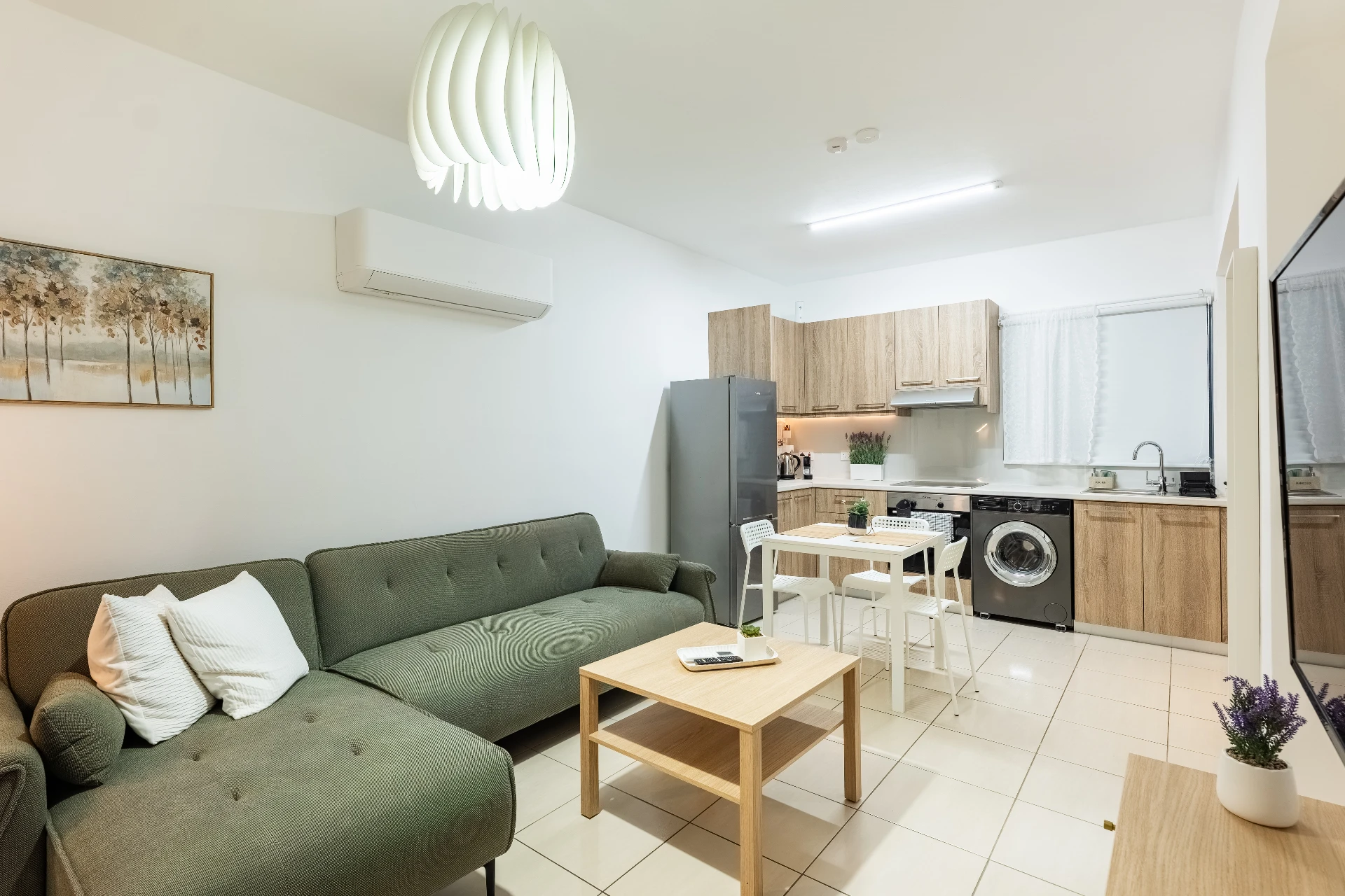 Open-plan living area with sofa and kitchen at Abitare Retreat, Paphos